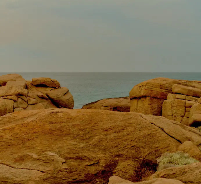 Coastal rock formations overlooking the ocean at dusk