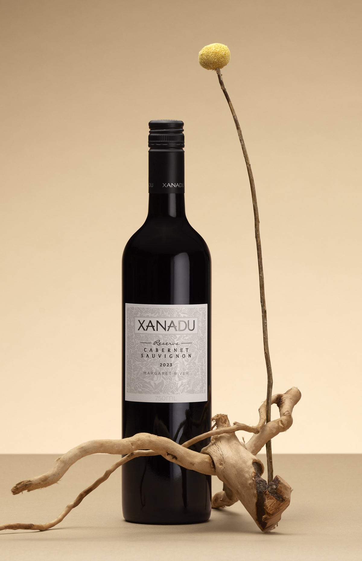 Xanadu Reserve Cabernet Sauvignon alongside billy button flower and timber
