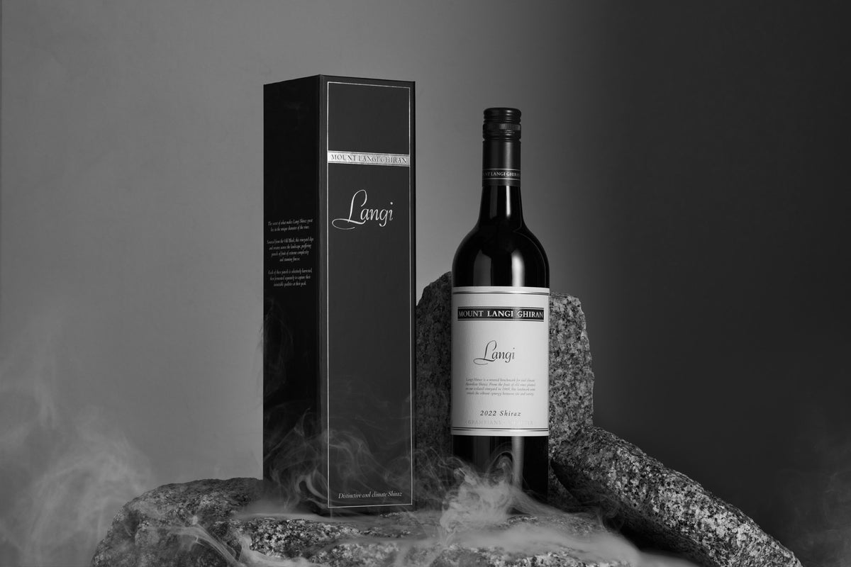 Bottle and gift box of Mount Langi Ghiran Langi Shiraz displayed on smoking rocks
